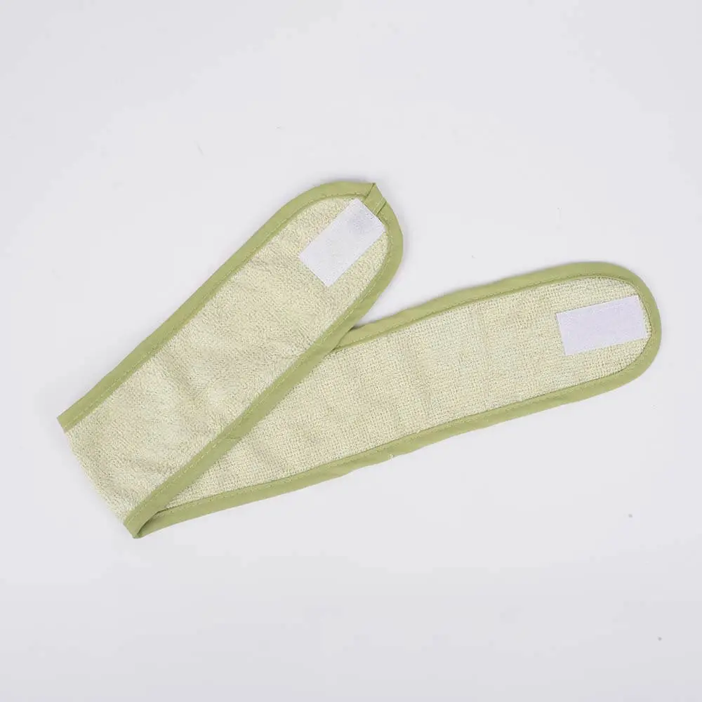 Green bamboo adjustable face wash headband DC-HDB001 spread flat to show velcro strap and full length design.